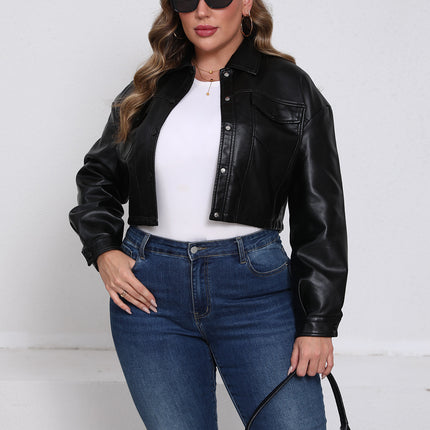 Women's black plus size cropped faux leather jacket on model with jeans